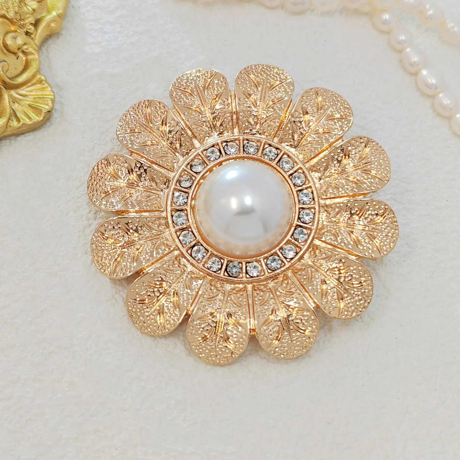 Elegant Gold - toned Floral Brooch with Pearl and Crystal Centerpiece