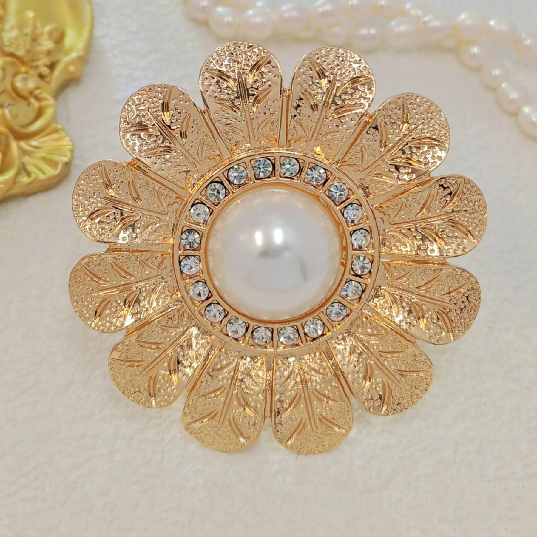 Elegant Gold - toned Floral Brooch with Pearl and Crystal Centerpiece