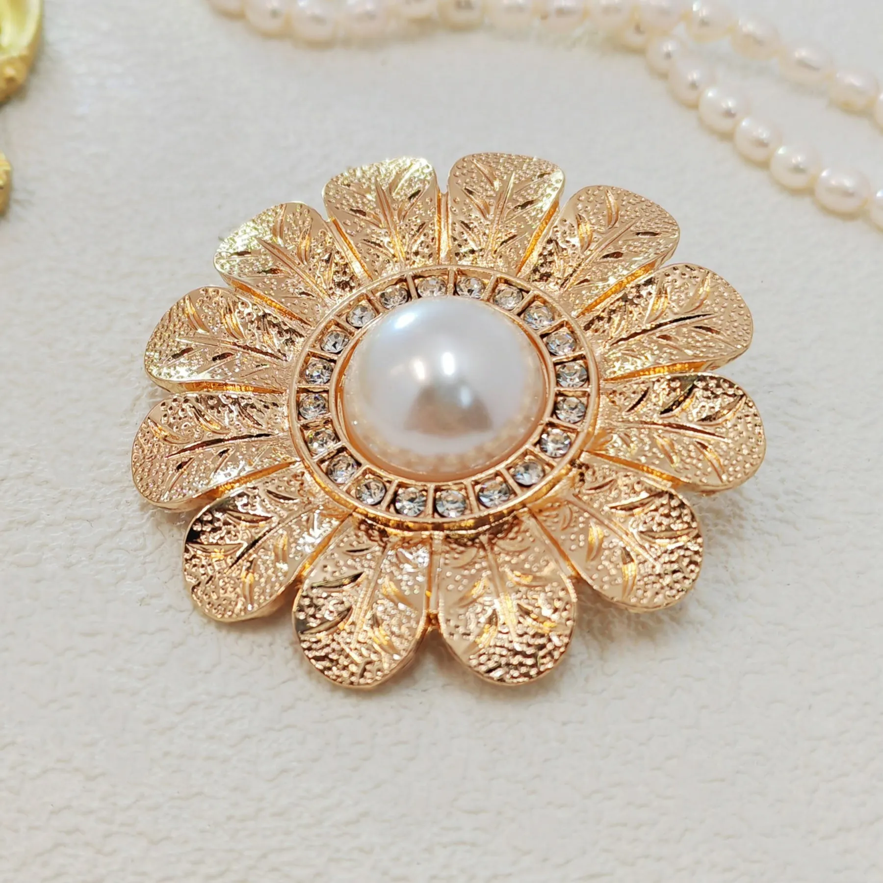 Elegant Gold - toned Floral Brooch with Pearl and Crystal Centerpiece