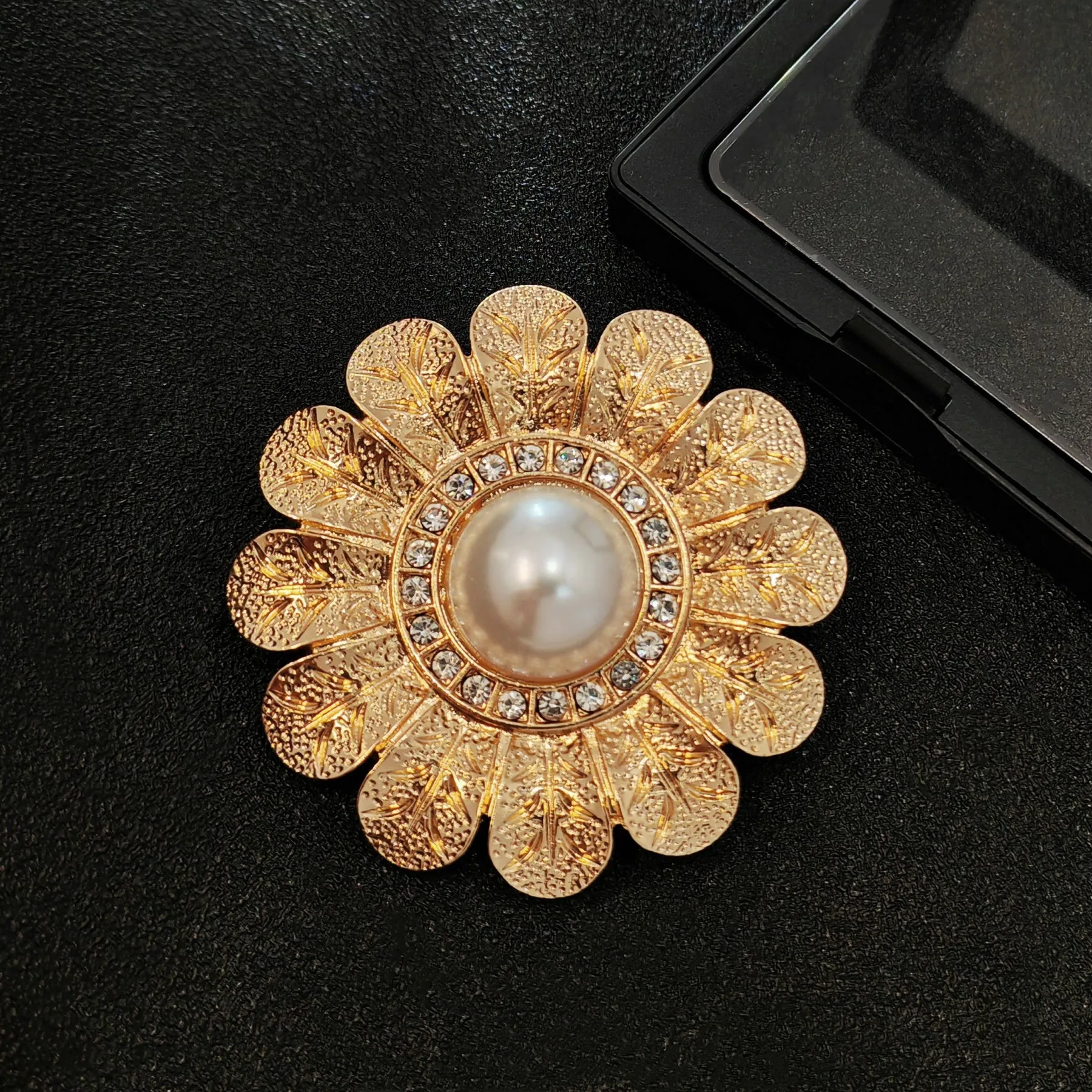 Elegant Gold - toned Floral Brooch with Pearl and Crystal Centerpiece