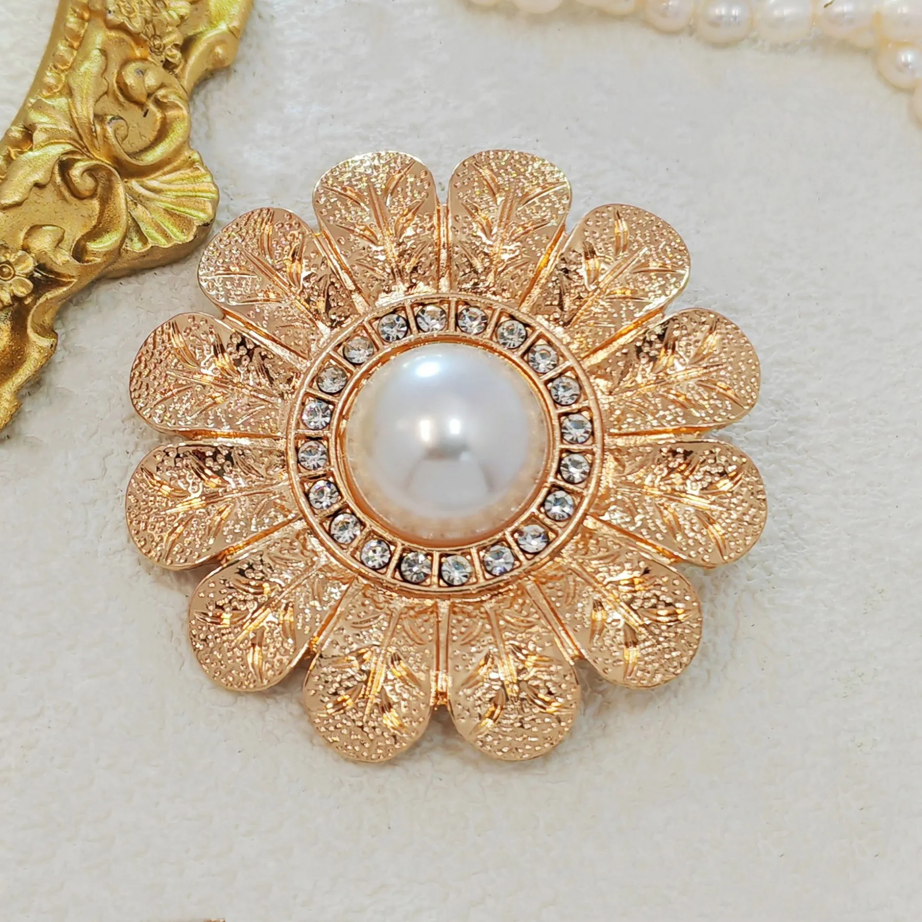 Elegant Gold - toned Floral Brooch with Pearl and Crystal Centerpiece