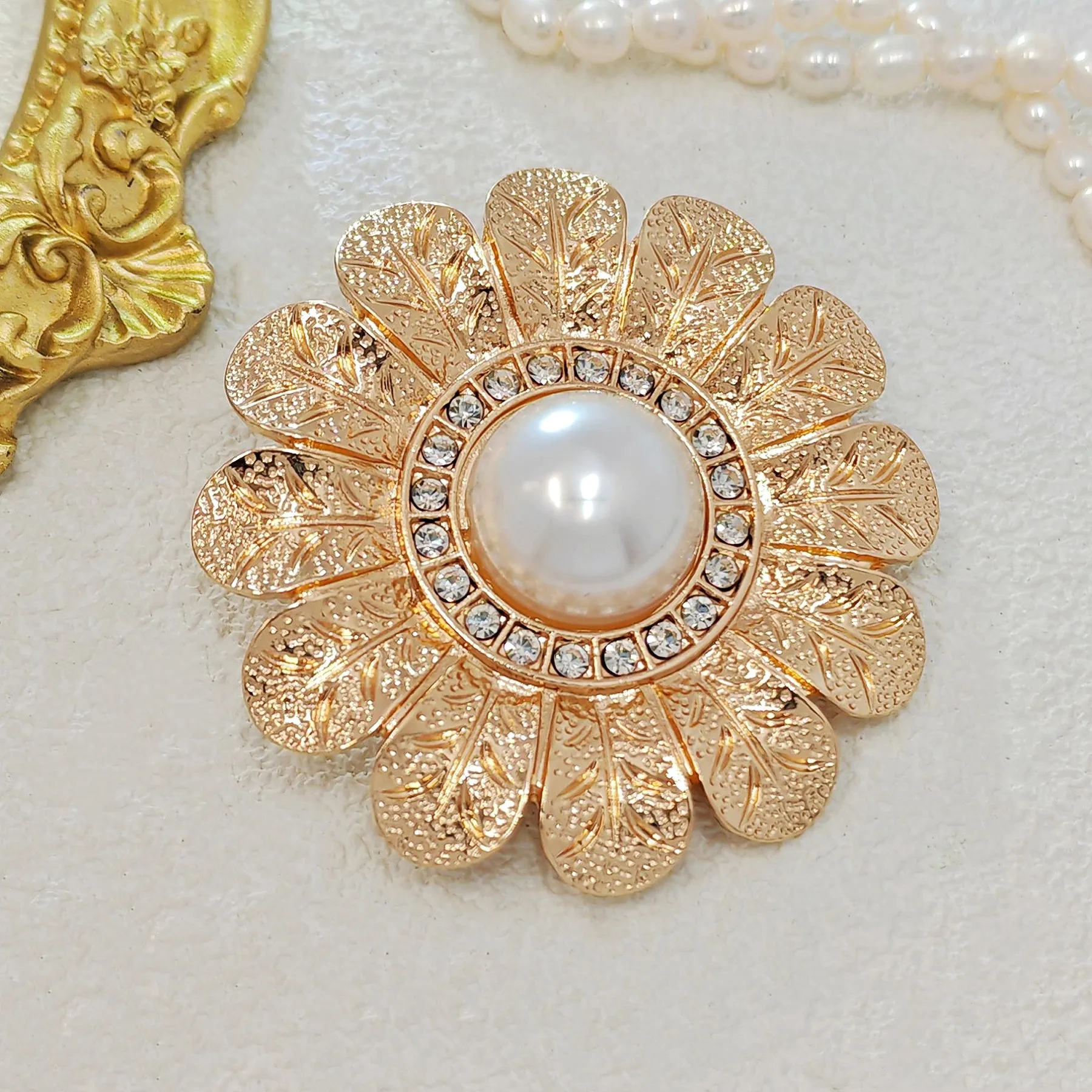 Elegant Gold - toned Floral Brooch with Pearl and Crystal Centerpiece