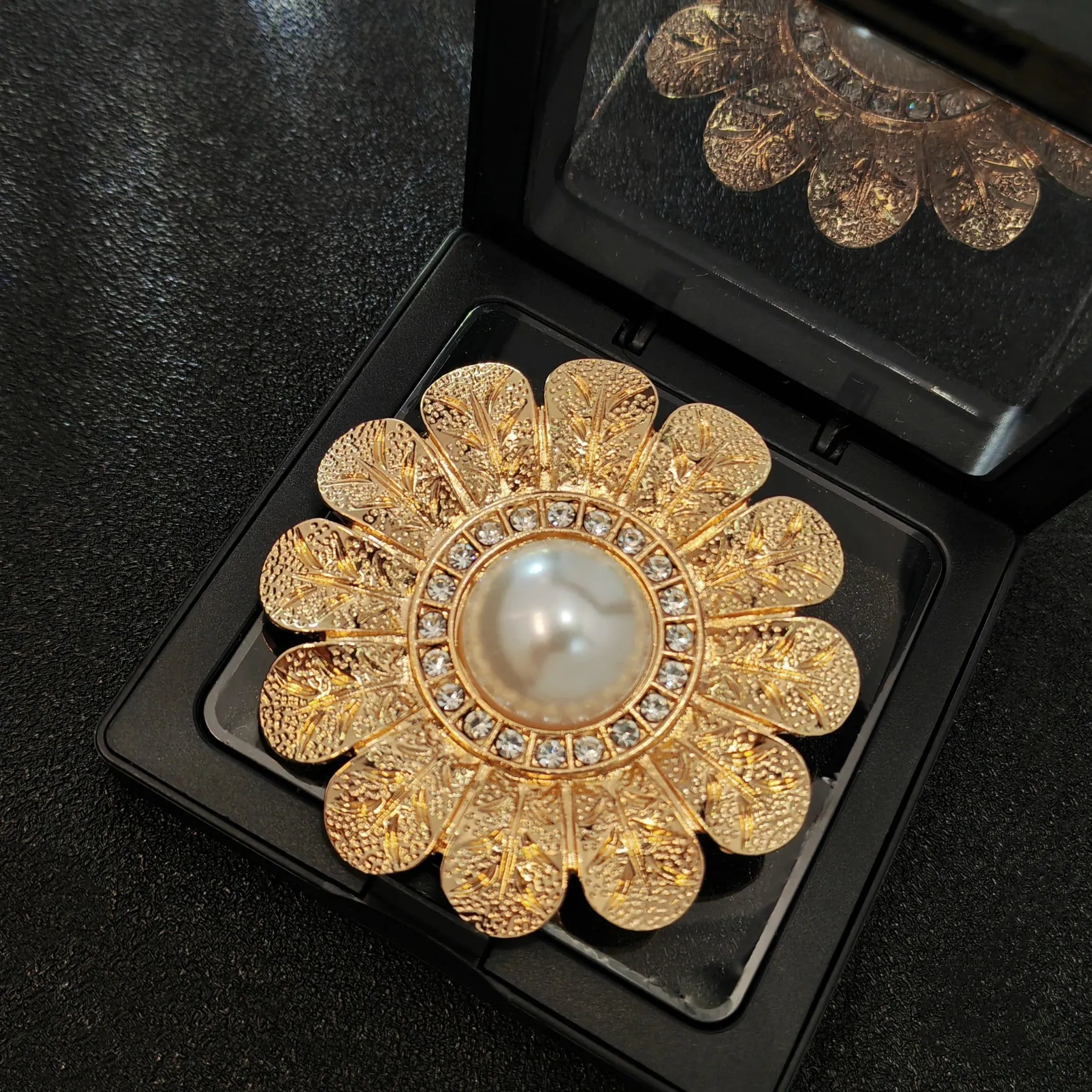 Elegant Gold - toned Floral Brooch with Pearl and Crystal Centerpiece