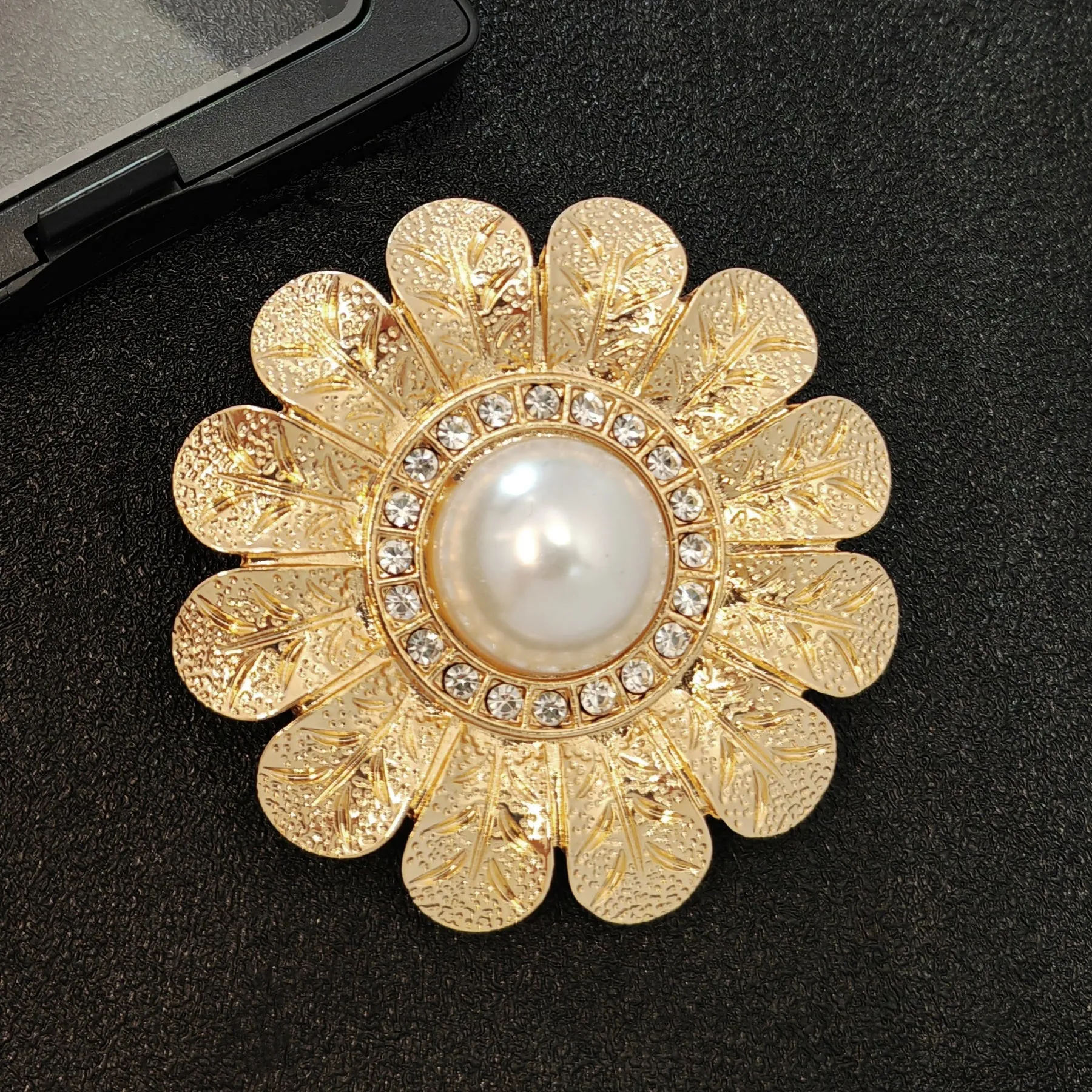 Elegant Gold - toned Floral Brooch with Pearl and Crystal Centerpiece