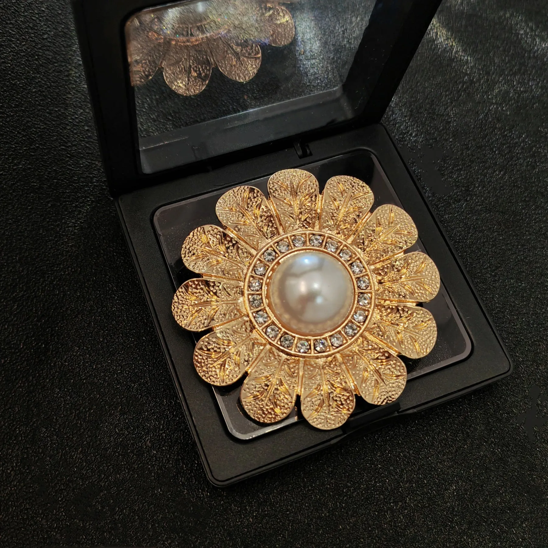 Elegant Gold - toned Floral Brooch with Pearl and Crystal Centerpiece